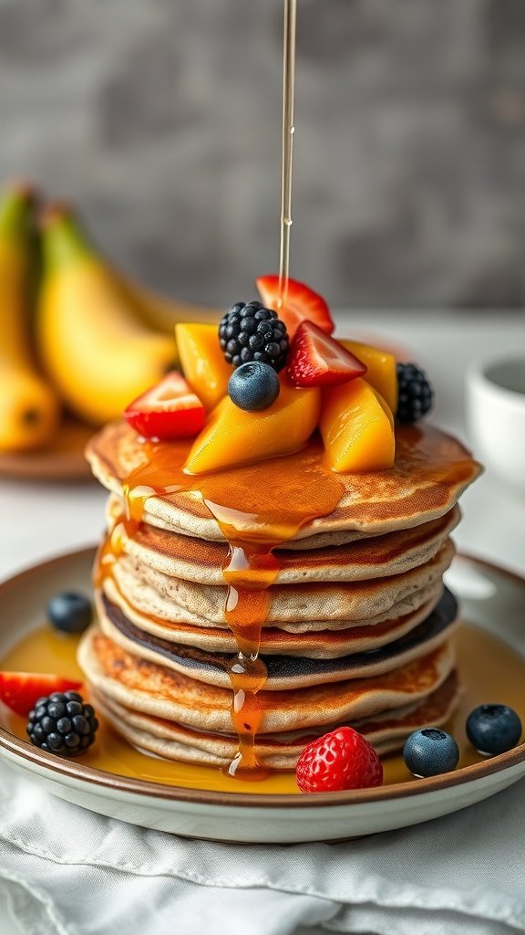 A stack of buckwheat pancakes topped with fresh fruits and maple syrup